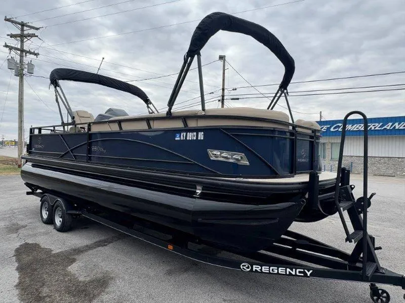 Slide: The Image of 2020 Regency 250 DL3 pontoon boat on trailer, parked outdoors. - 17