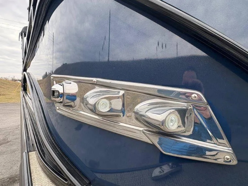 Slide: The Image of 2020 Regency 250 DL3 boat with sleek chrome detailing and reflective blue surface. - 22