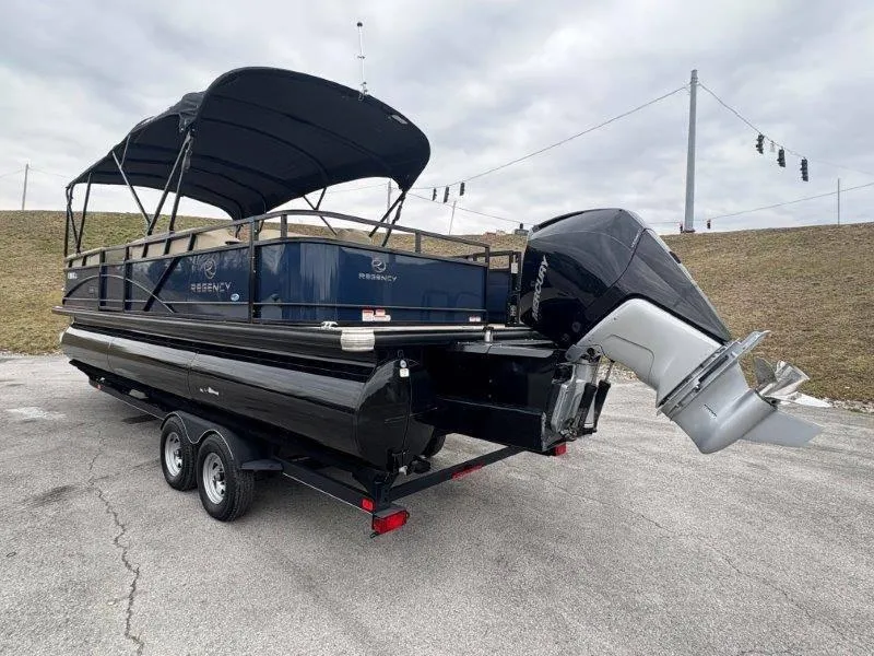 Slide: The Image of 2020 Regency 250 DL3 pontoon boat with canopy and outboard motor on trailer. - 32