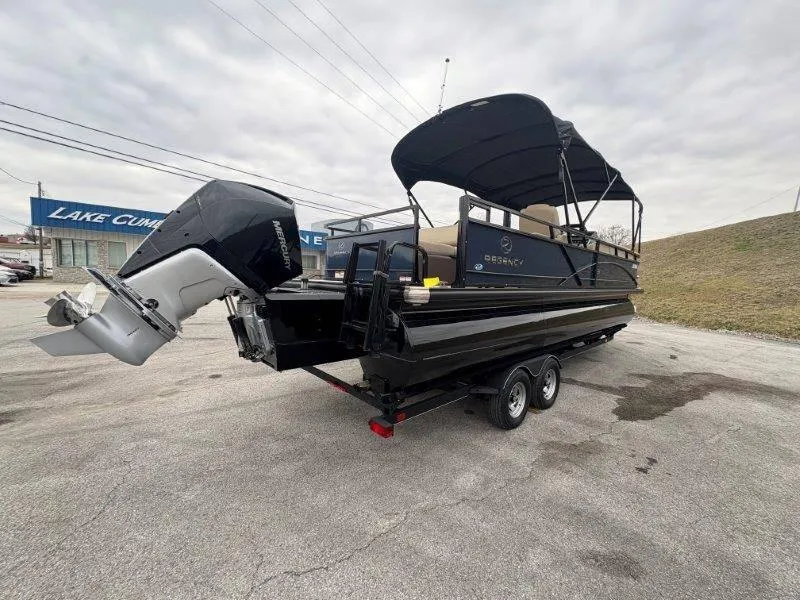 Slide: The Image of 2020 Regency 250 DL3 pontoon boat with canopy and outboard motor on trailer. - 34
