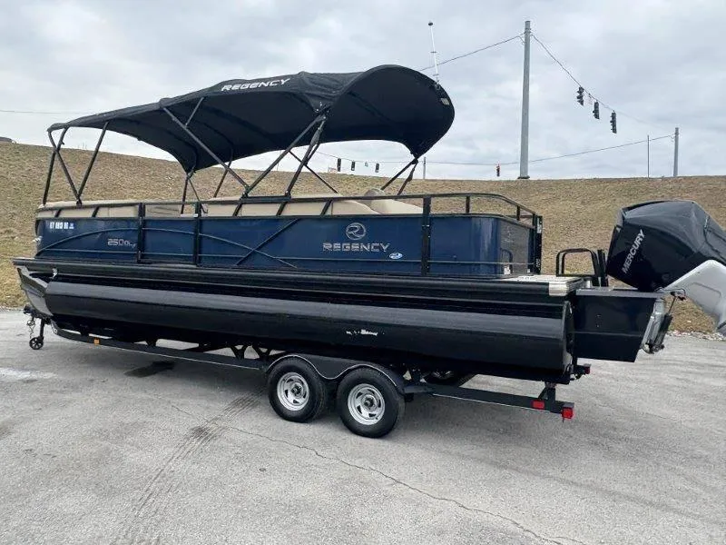 Slide: The Image of 2020 Regency 250 DL3 pontoon boat on trailer, featuring a black canopy. - 36