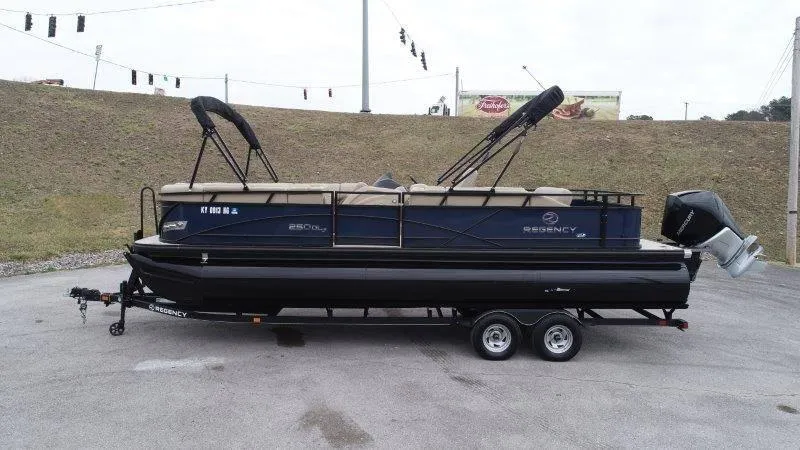 Slide: The Image of 2020 Regency 250 DL3 pontoon boat on trailer, parked outdoors. - 4