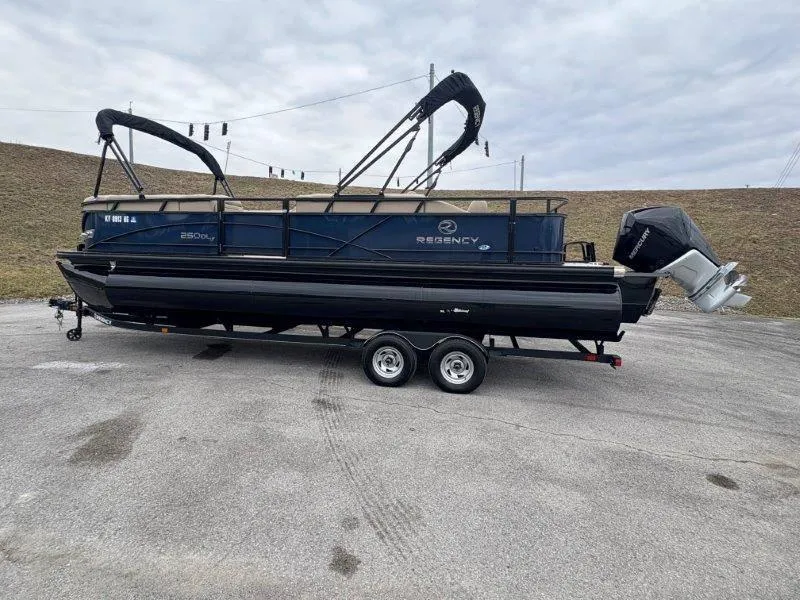 Slide: The Image of 2020 Regency 250 DL3 pontoon boat on trailer, parked outdoors. - 42
