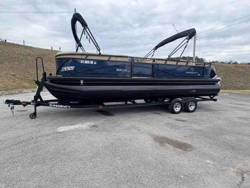 Slide: The Image of 2020 Regency 250 DL3 pontoon boat on trailer, parked outdoors. - 47