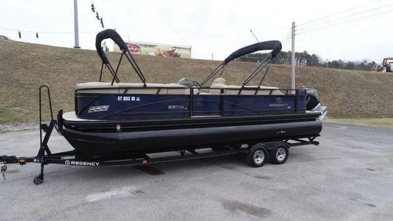 Slide: The Image of 2020 Regency 250 DL3 pontoon boat on trailer in parking lot. - 6