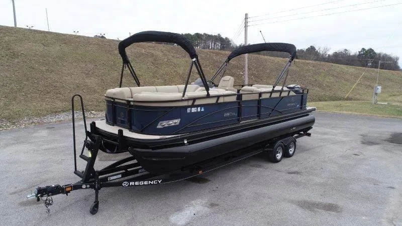 Slide: The Image of 2020 Regency 250 DL3 pontoon boat on trailer, parked outdoors. - 7