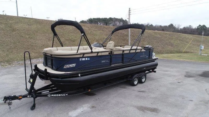 Slide: The Image of 2020 Regency 250 DL3 pontoon boat on trailer, parked outdoors. - 9