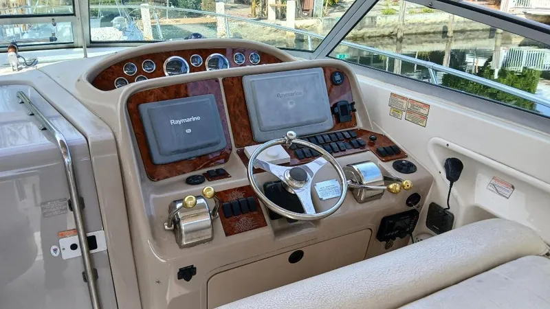 Slide: The Image of Cockpit of 2000 Sea Ray Amberjack 340 with steering wheel and navigation controls. - 3