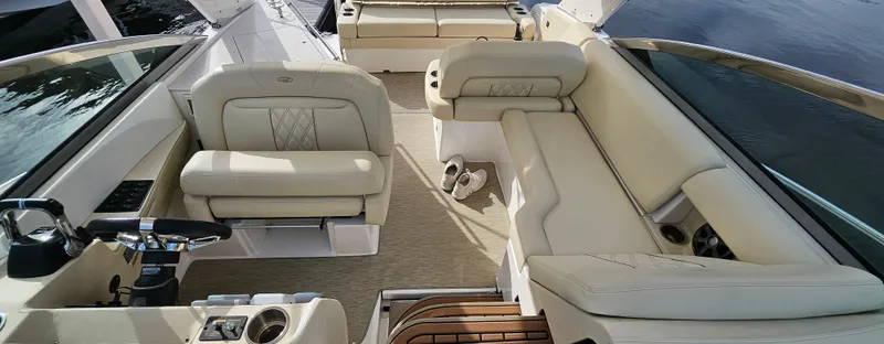 Slide: The Image of 2018 Regal 33 XO boat interior with beige seating and steering wheel. - 19