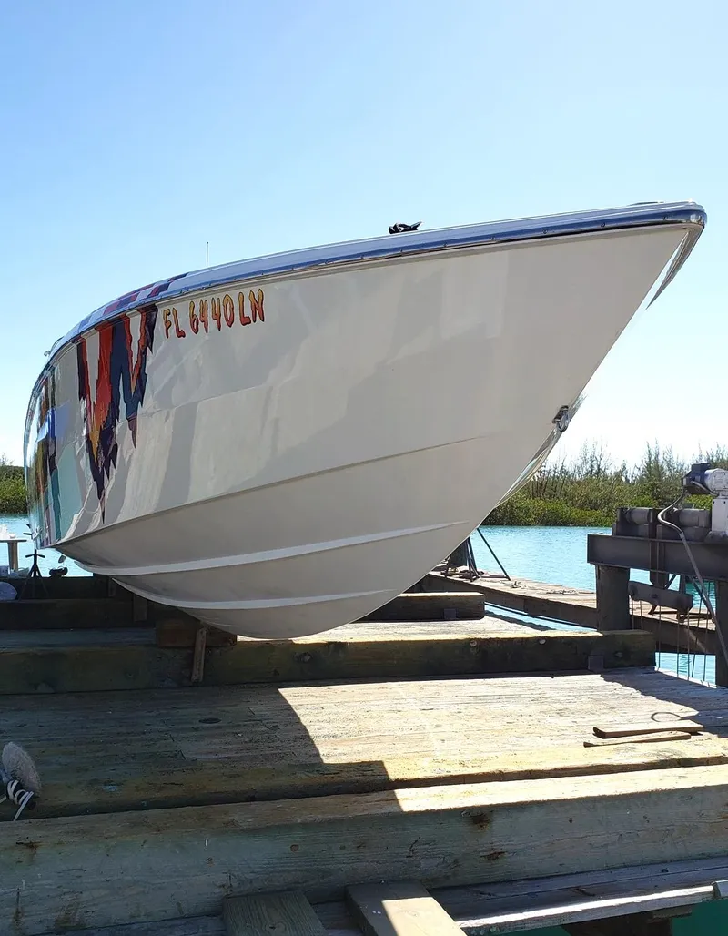 Slide: The Image of 2001 Nor-Tech 500 boat on dock, viewed from the front, under clear blue sky. - 2