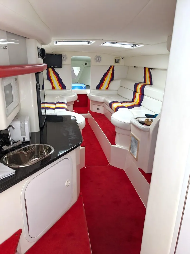 Slide: The Image of Interior of 2001 Nor-Tech 500 boat with vibrant seating and modern amenities. - 5