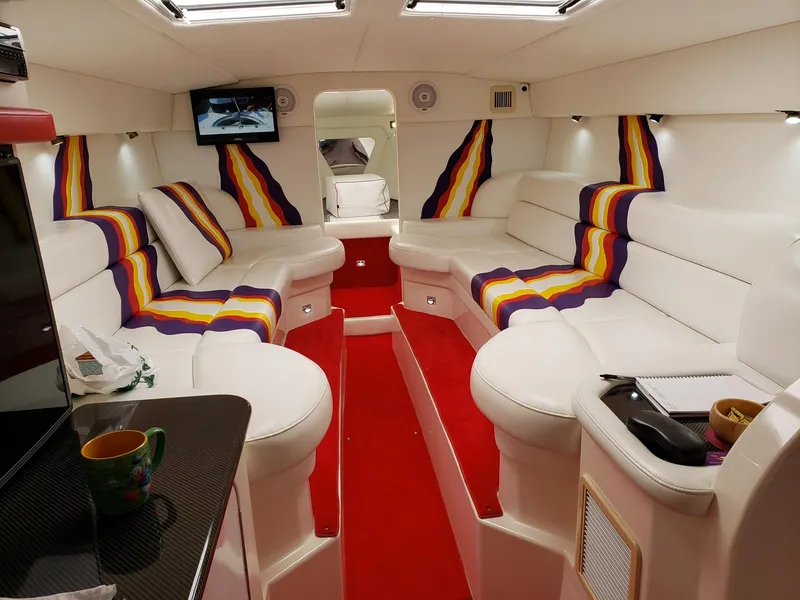 Slide: The Image of Luxurious interior of a 2001 Nor-Tech 500 boat with vibrant seating and modern amenities. - 7