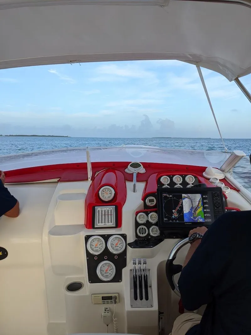 Slide: The Image of Interior view of a 2001 Nor-Tech 500 boat dashboard with ocean in the background. - 9