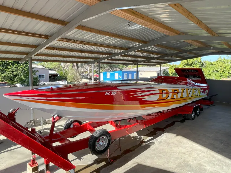 Slide: The Image of 2002 Cigarette ROUGH RIDER speedboat on trailer under metal canopy. - 19