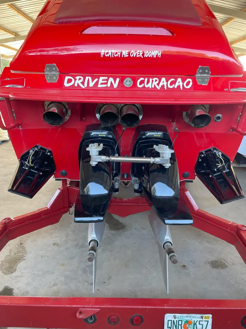 Slide: The Image of Rear view of a 2002 Cigarette ROUGH RIDER boat, red with dual engines. - 20