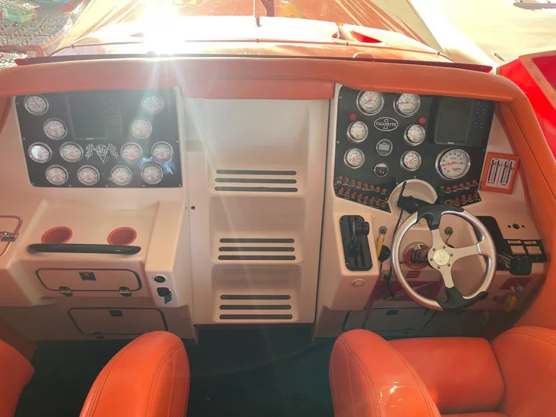 Slide: The Image of Dashboard of 2002 Cigarette ROUGH RIDER boat with orange seats and multiple gauges. - 3