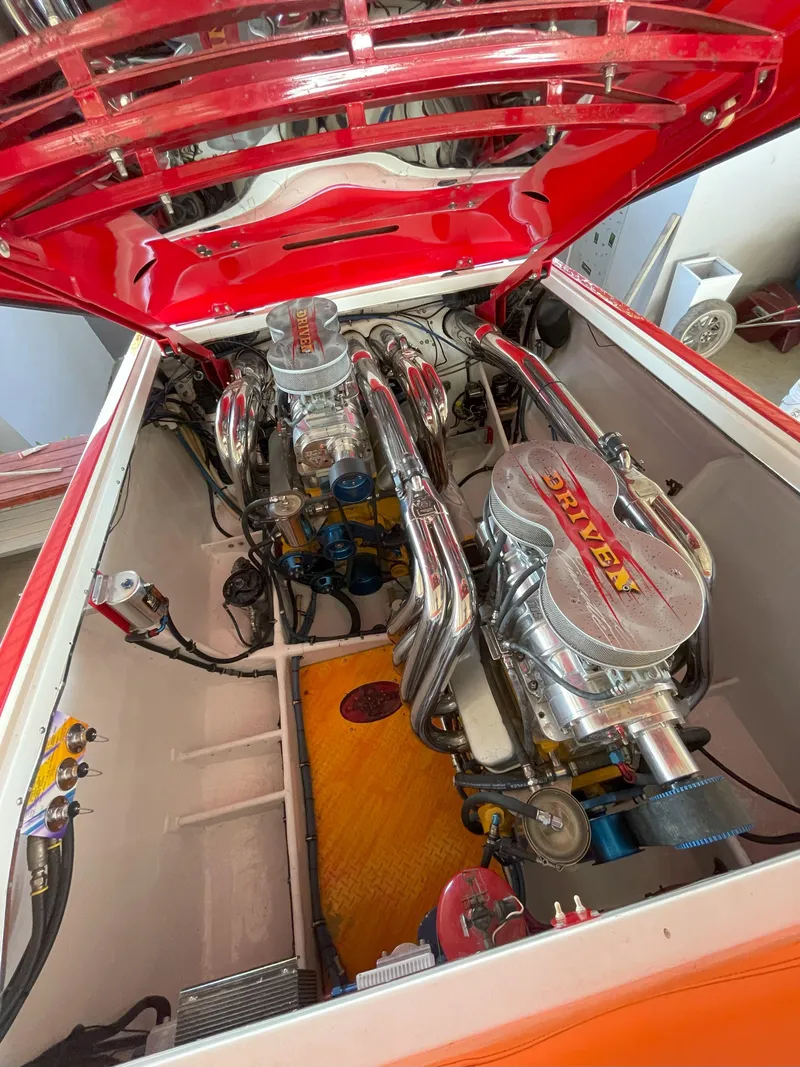 Slide: The Image of Engine compartment of a 2002 Cigarette ROUGH RIDER boat, showcasing dual high-performance engines. - 8