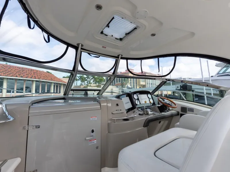 Slide: The Image of 2005 Sea Ray 390 Sundancer helm with modern controls and comfortable seating. - 10