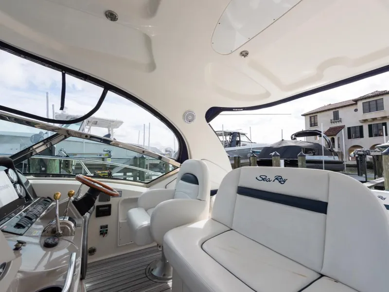 Slide: The Image of Interior of 2005 Sea Ray 390 Sundancer yacht with luxurious seating and helm. - 11