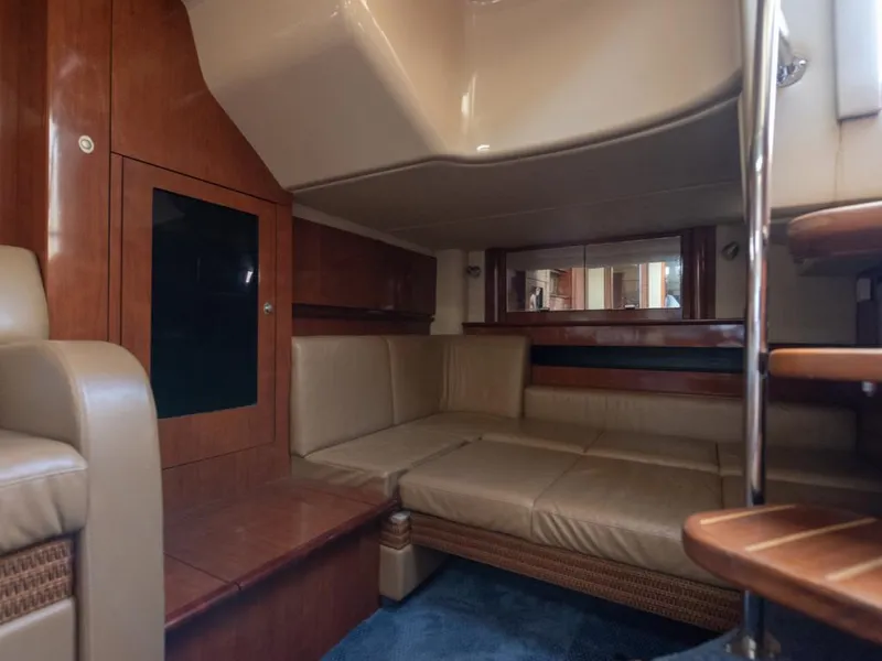 Slide: The Image of Interior of 2005 Sea Ray 390 Sundancer yacht with beige seating and wooden accents. - 17
