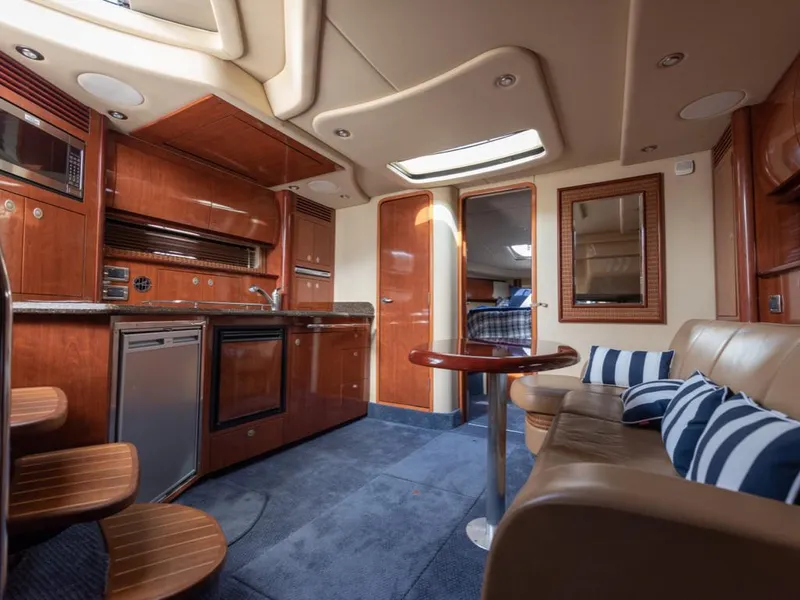 Slide: The Image of Luxurious interior of 2005 Sea Ray 390 Sundancer yacht with kitchen and seating area. - 20
