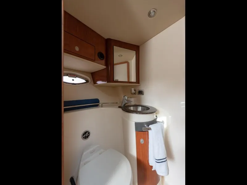 Slide: The Image of 2005 Sea Ray 390 Sundancer bathroom with sink, mirror, and toilet. - 24