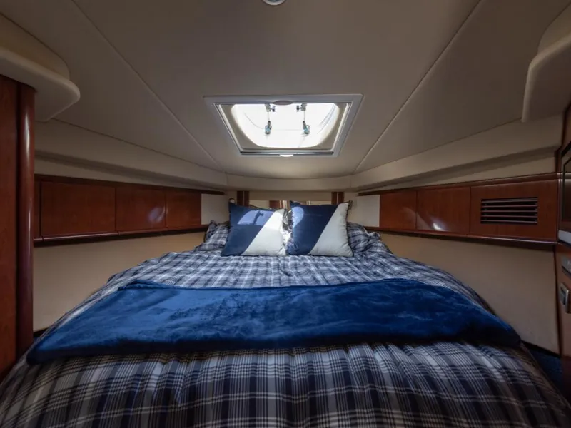 Slide: The Image of Luxurious cabin interior of 2005 Sea Ray 390 Sundancer with cozy bedding and skylight. - 25
