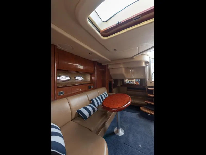 Slide: The Image of Interior of 2005 Sea Ray 390 Sundancer yacht with leather seating and striped cushions. - 28