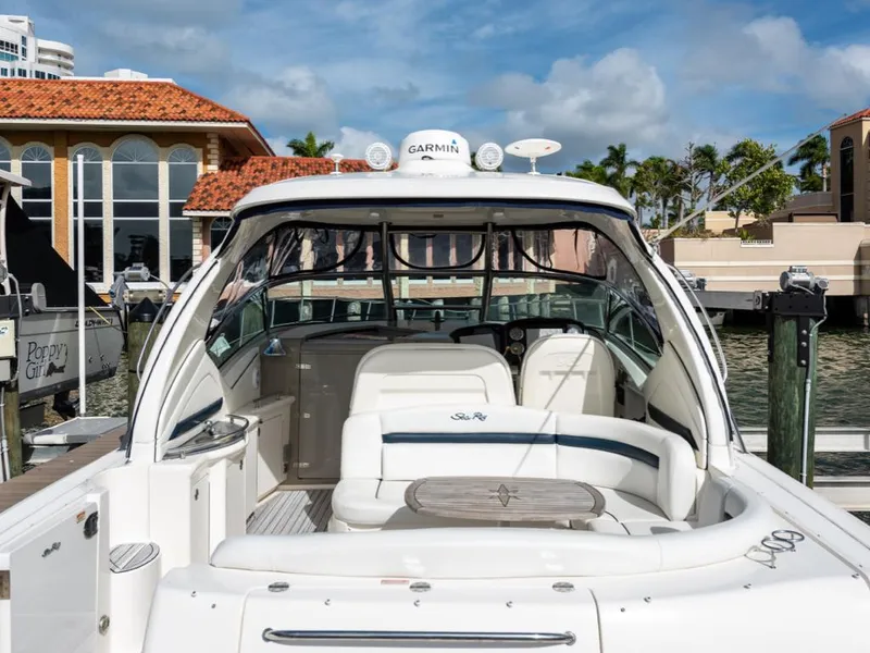 Slide: The Image of 2005 Sea Ray 390 Sundancer yacht docked at marina, featuring spacious seating and modern design. - 4
