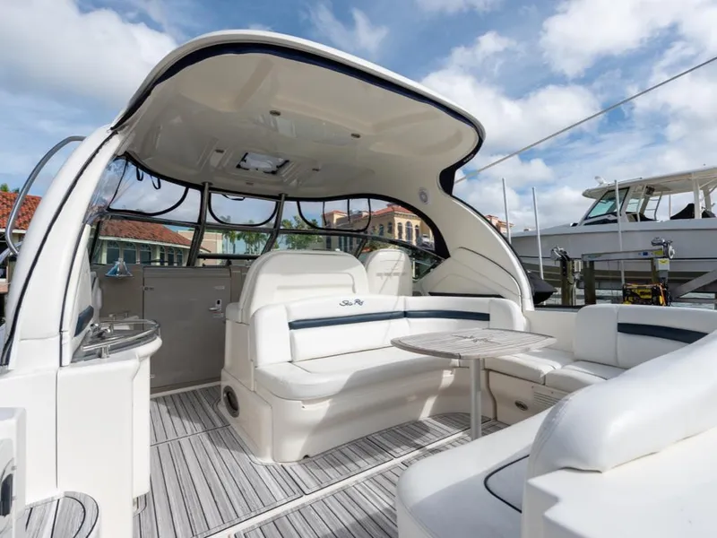 Slide: The Image of 2005 Sea Ray 390 Sundancer yacht interior with seating and table under canopy. - 6