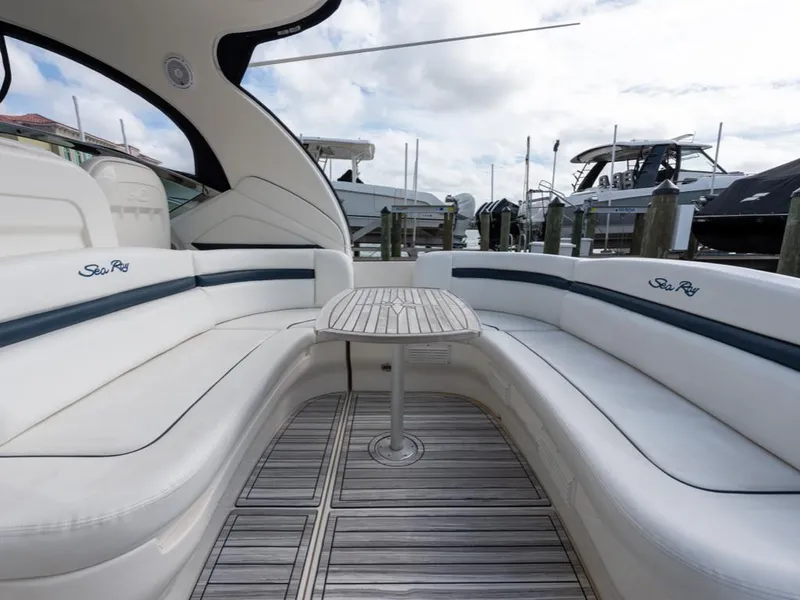 Slide: The Image of 2005 Sea Ray 390 Sundancer yacht with elegant seating and wooden table. - 7