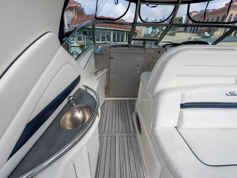 Slide: The Image of 2005 Sea Ray 390 Sundancer interior with seating and sink, showcasing luxury yacht design. - 9