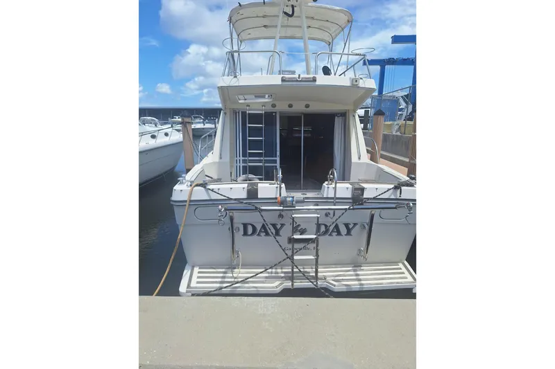 Slide: The Image of 1988 Birchwood 44TS yacht docked at marina under blue sky. - 1