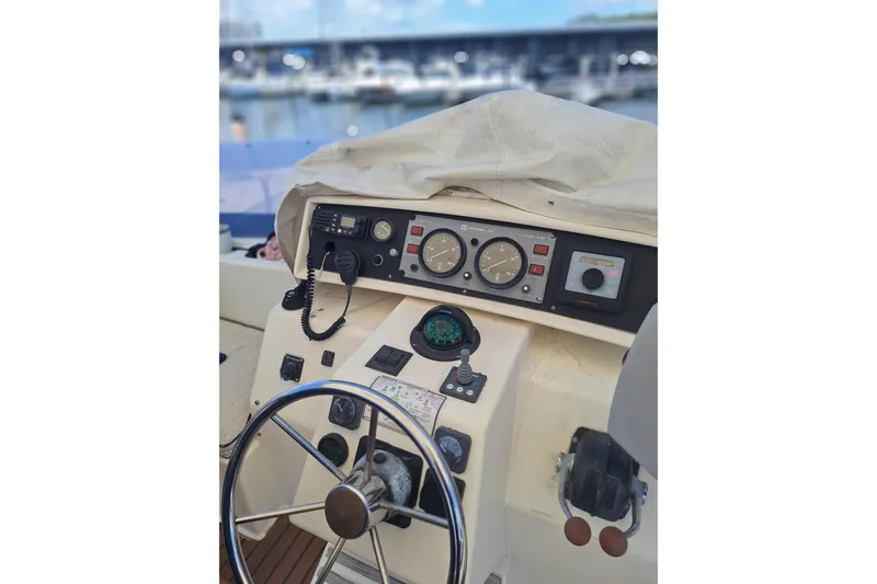 Slide: The Image of Helm of 1988 Birchwood 44TS boat with steering wheel and navigation instruments. - 10