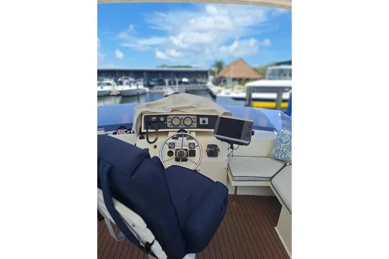 Slide: The Image of Interior view of 1988 Birchwood 44TS yacht cockpit with navigation equipment and seating. - 11