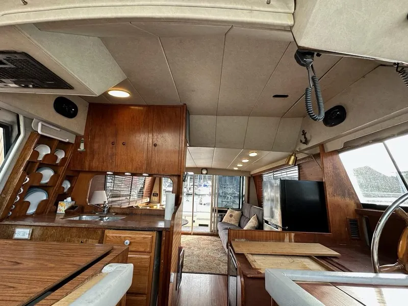 Slide: The Image of Interior of a 1988 Birchwood 44TS yacht with wood furnishings and modern amenities. - 44