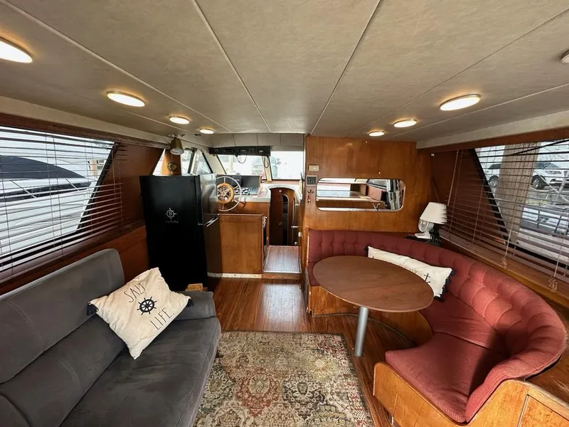 Slide: The Image of Interior of 1988 Birchwood 44TS yacht with cozy seating and wooden accents. - 45