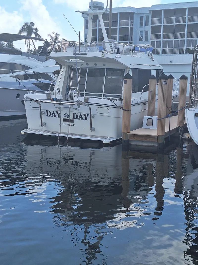 Slide: The Image of 1988 Birchwood 44TS yacht docked at marina, reflecting on calm water. - 46