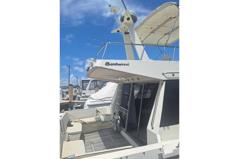 Slide: The Image of 1988 Birchwood 44TS yacht docked under clear blue sky. - 5
