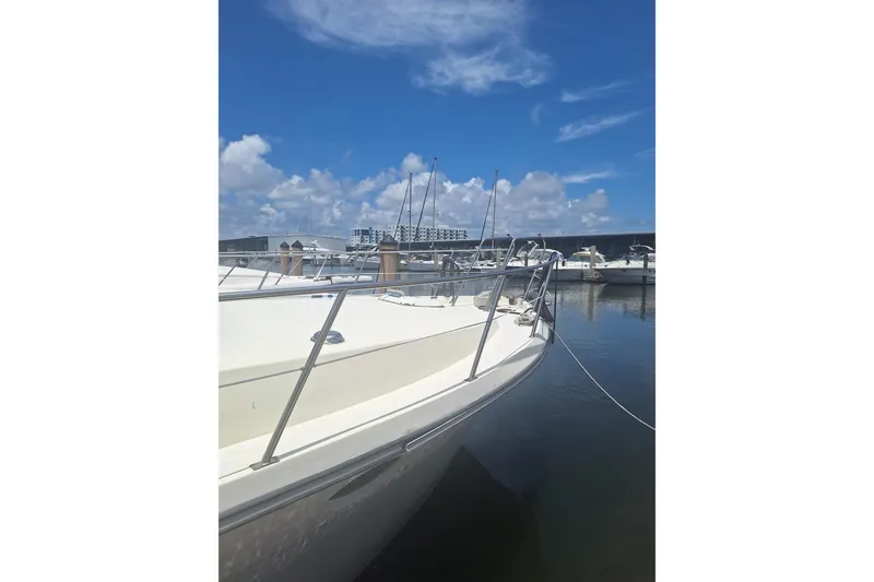 Slide: The Image of 1988 Birchwood 44TS yacht docked at marina under clear blue sky. - 6