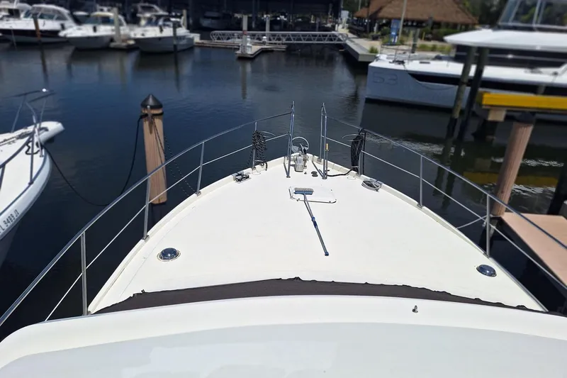 Slide: The Image of Bow view of 1988 Birchwood 44TS yacht docked in a marina. - 7