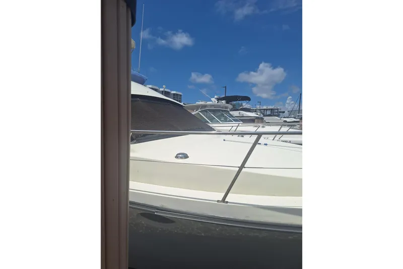 Slide: The Image of 1988 Birchwood 44TS yacht docked under a clear blue sky. - 8