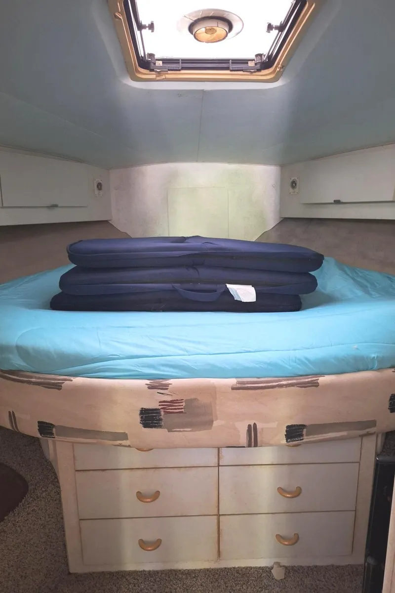 Slide: The Image of Interior cabin of 1992 Silverton 34 Convertible boat with bed and storage. - 14