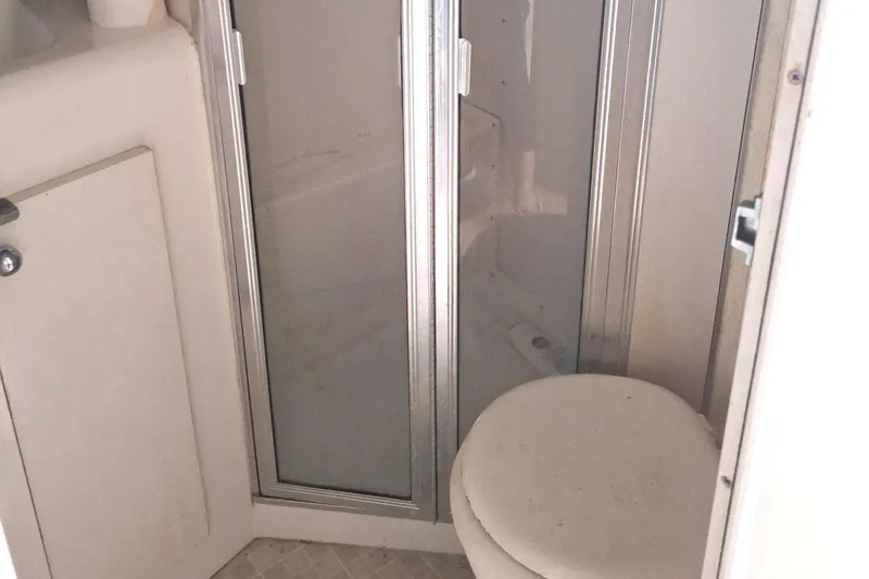 Slide: The Image of Bathroom interior of 1992 Silverton 34 Convertible boat with shower and toilet. - 15