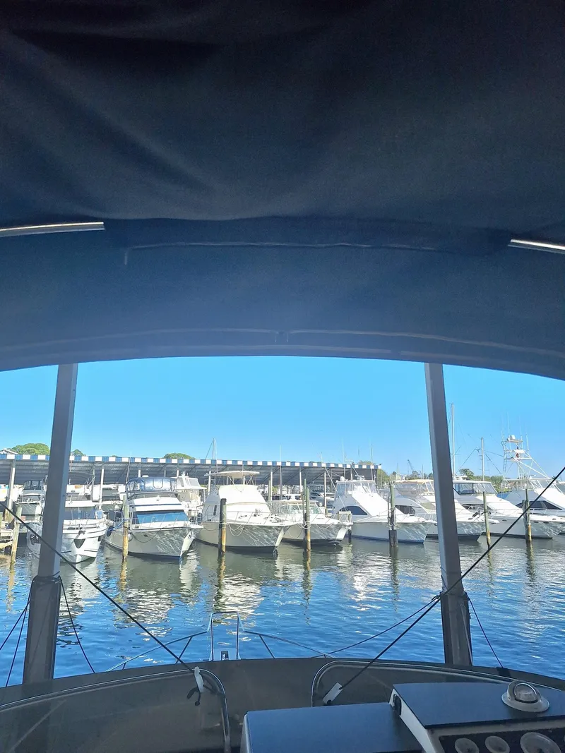 Slide: The Image of View from a 1992 Silverton 34 Convertible boat overlooking a marina with docked boats. - 5