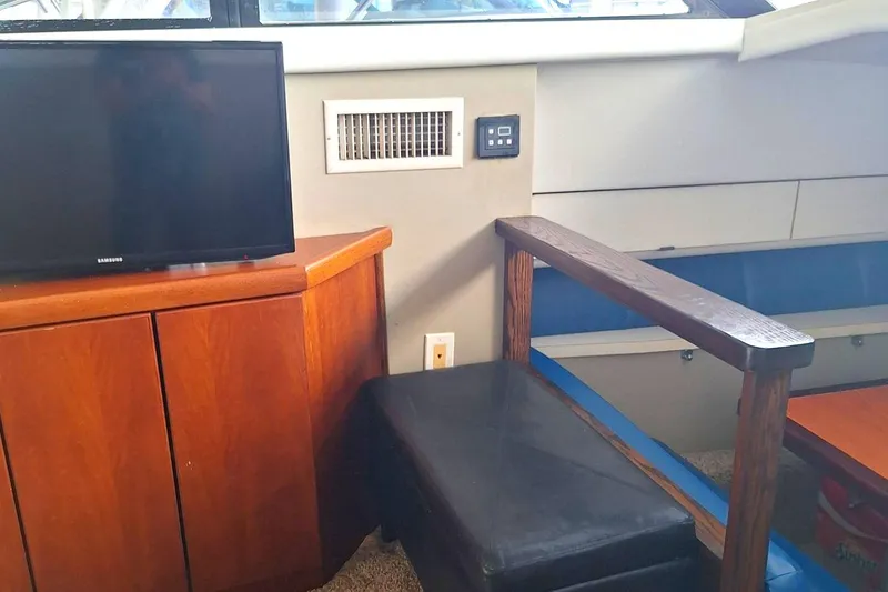 Slide: The Image of Interior of 1992 Silverton 34 Convertible with TV, wooden cabinet, and seating area. - 7