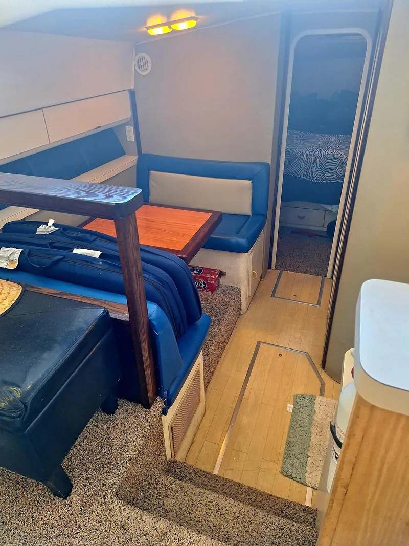 Slide: The Image of Interior of 1992 Silverton 34 Convertible yacht with cozy seating and wooden table. - 8