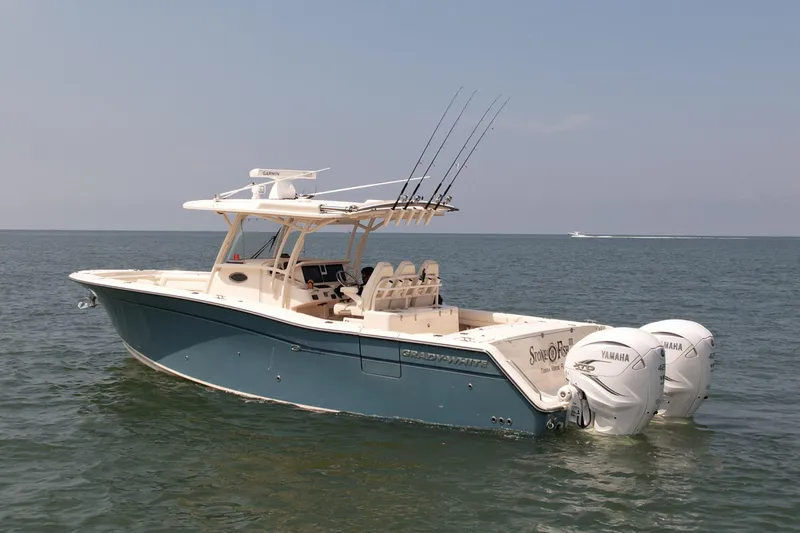 Slide: The Image of 2019 Grady-White Canyon 336 boat on open water with dual Yamaha engines. - 0