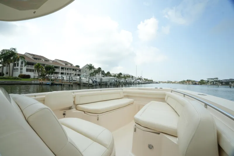 Slide: The Image of 2019 Grady-White Canyon 336 boat interior with waterfront view and luxurious seating. - 11