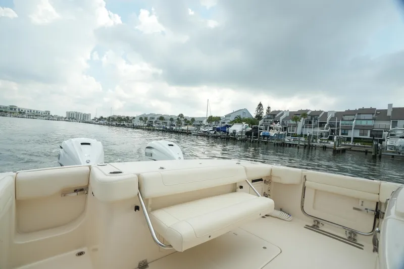 Slide: The Image of 2019 Grady-White Canyon 336 boat interior with waterfront view and cloudy sky. - 16